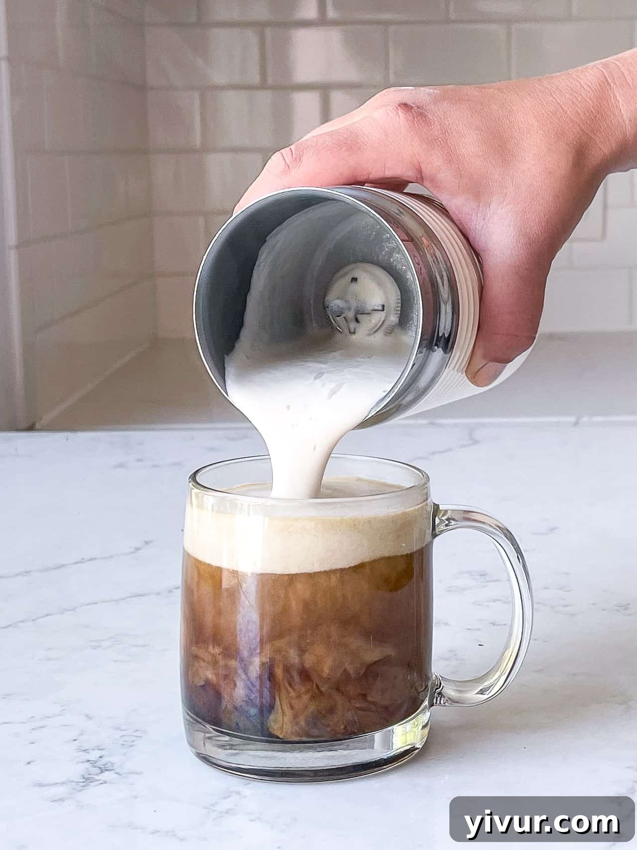 Pouring frothed milk into coffee for a keto superfood latte