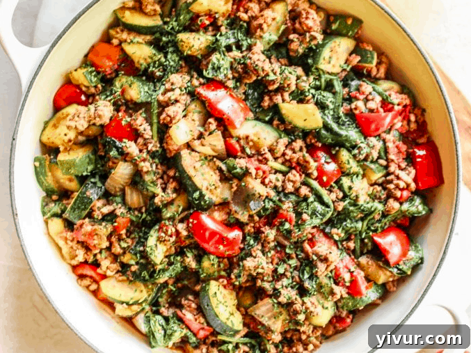 A simple yet satisfying easy turkey and zucchini skillet, showcasing crumbled ground turkey, tender zucchini pieces, and fresh green herbs in a sturdy pan.