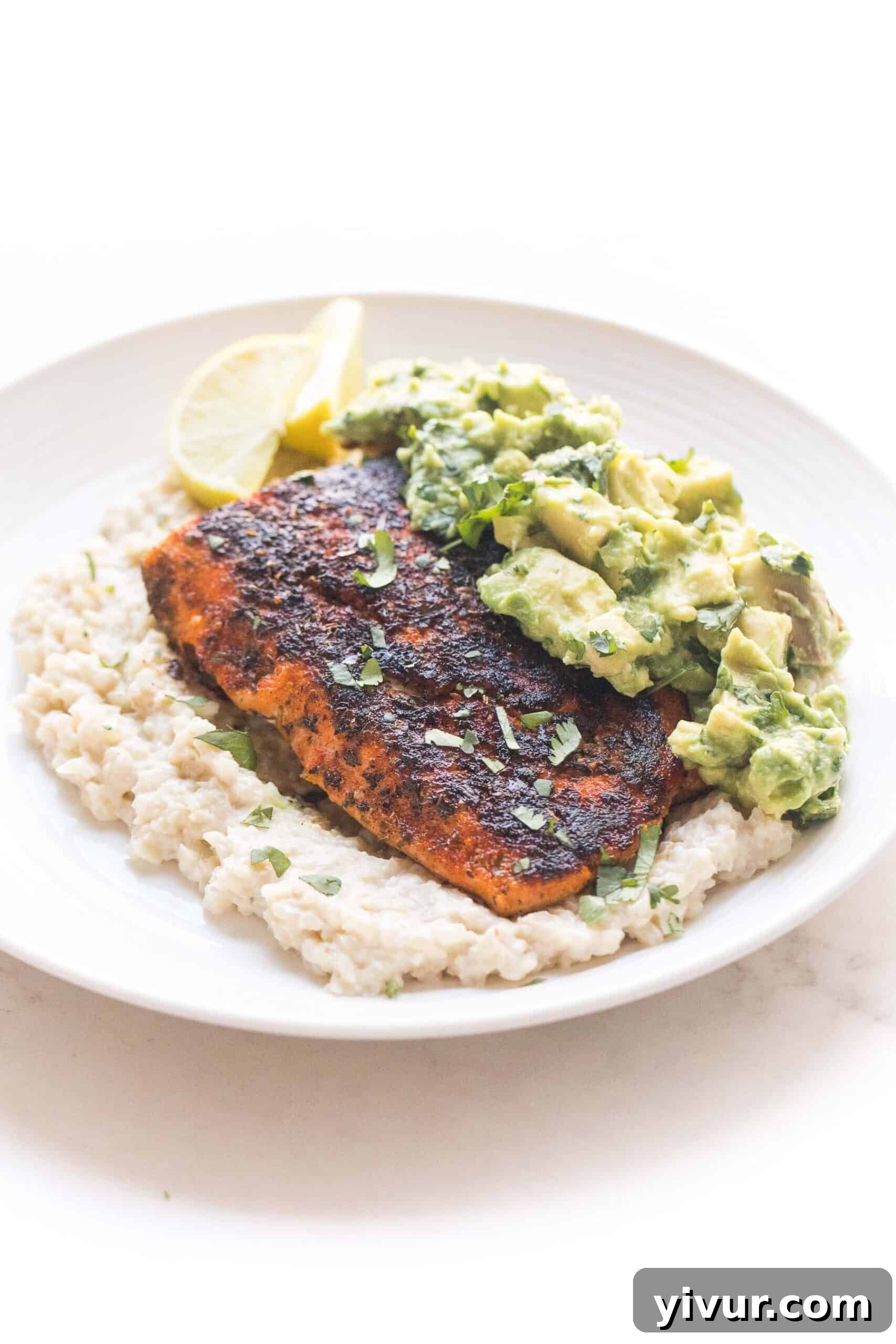 whole30 + keto blackened salmon over cauliflower risotto with chunky avocado topping