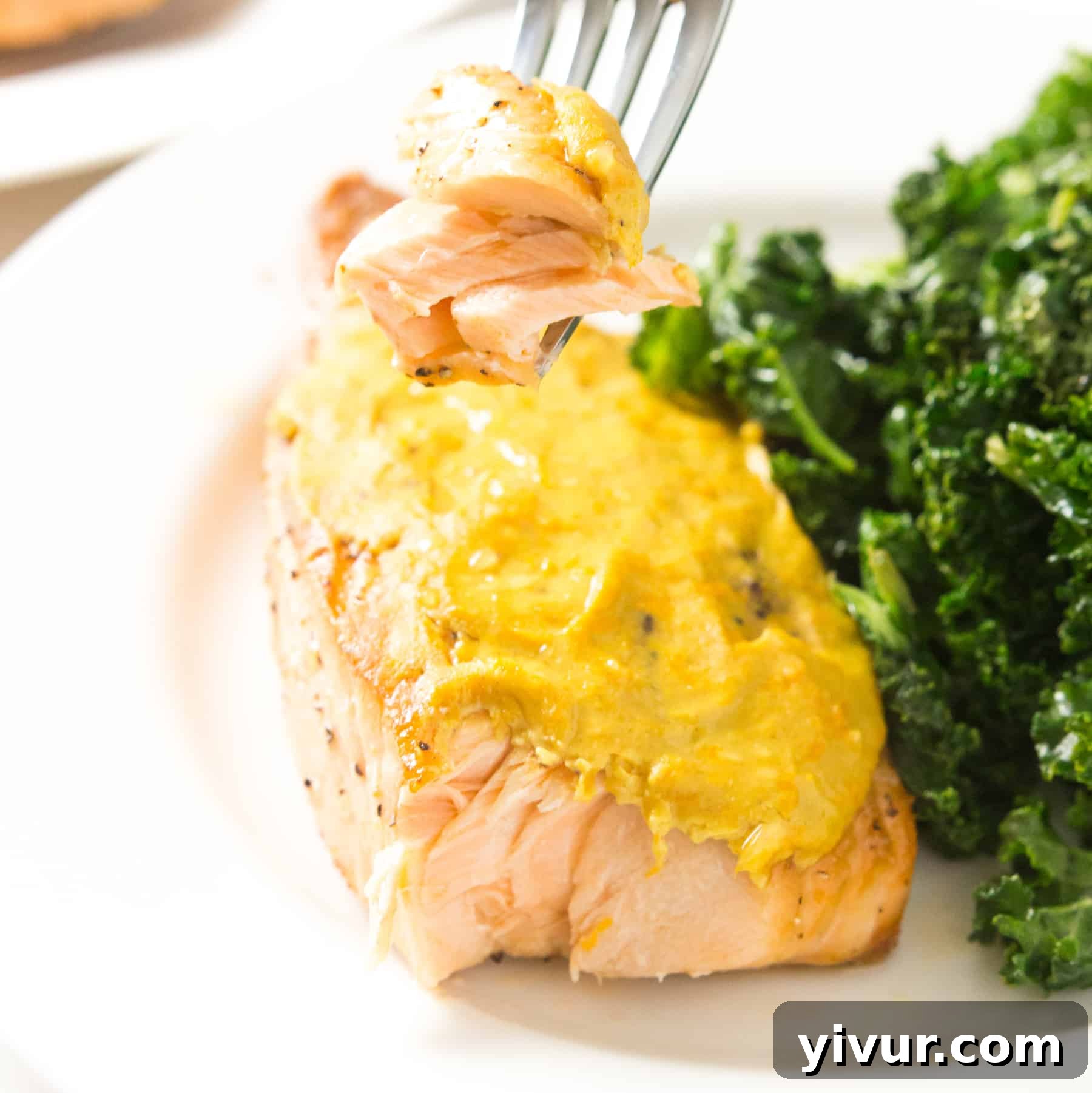 Orange Mustard Glazed Salmon on a plate with greens