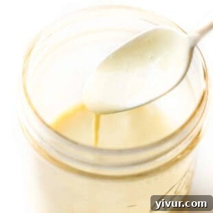 Keto Hollandaise Sauce in a jar with an immersion blender