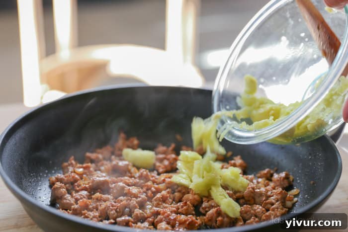 Adding zucchini flesh to the sausage mixture