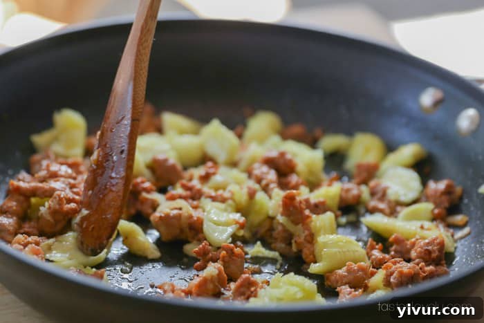 Zucchini flesh cooking down with sausage