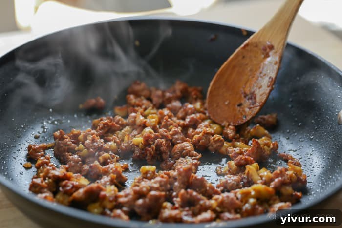 Garlic added to the sausage and zucchini mixture