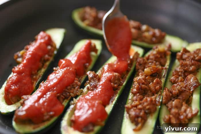 Stuffed zucchini topped with tomato sauce