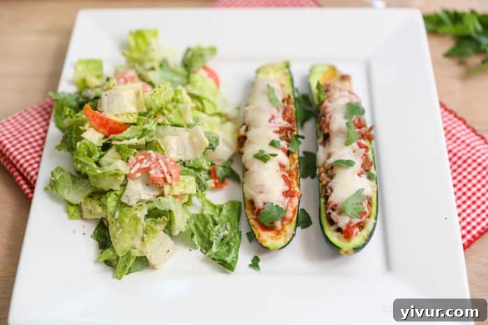 Sausage Stuffed Zucchini served with a salad