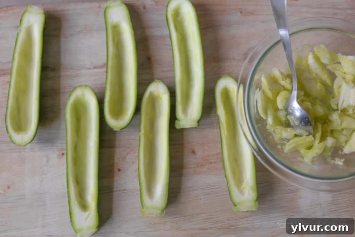 All zucchini halves scooped out, with flesh reserved