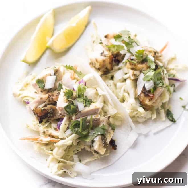 Whole30 + keto cilantro lime chicken tacos with coleslaw on trader joe's jicama wraps