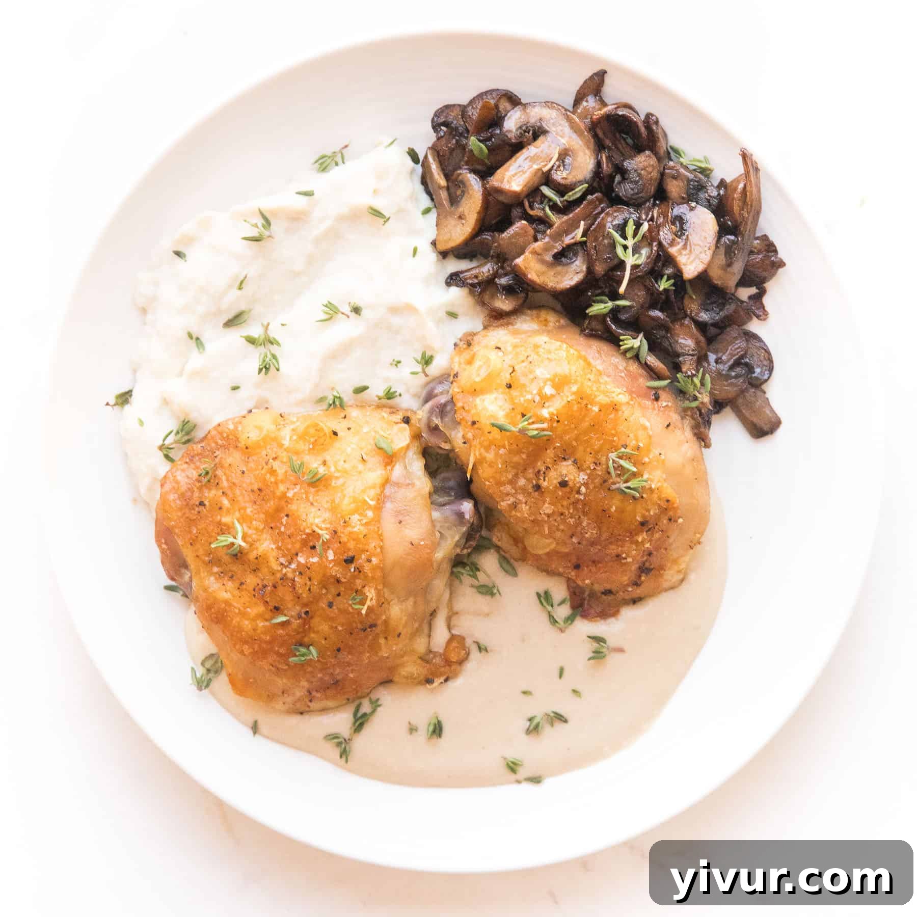 Crispy chicken thighs coated in a creamy mustard sauce, served with mashed cauliflower and sautéed mushrooms.