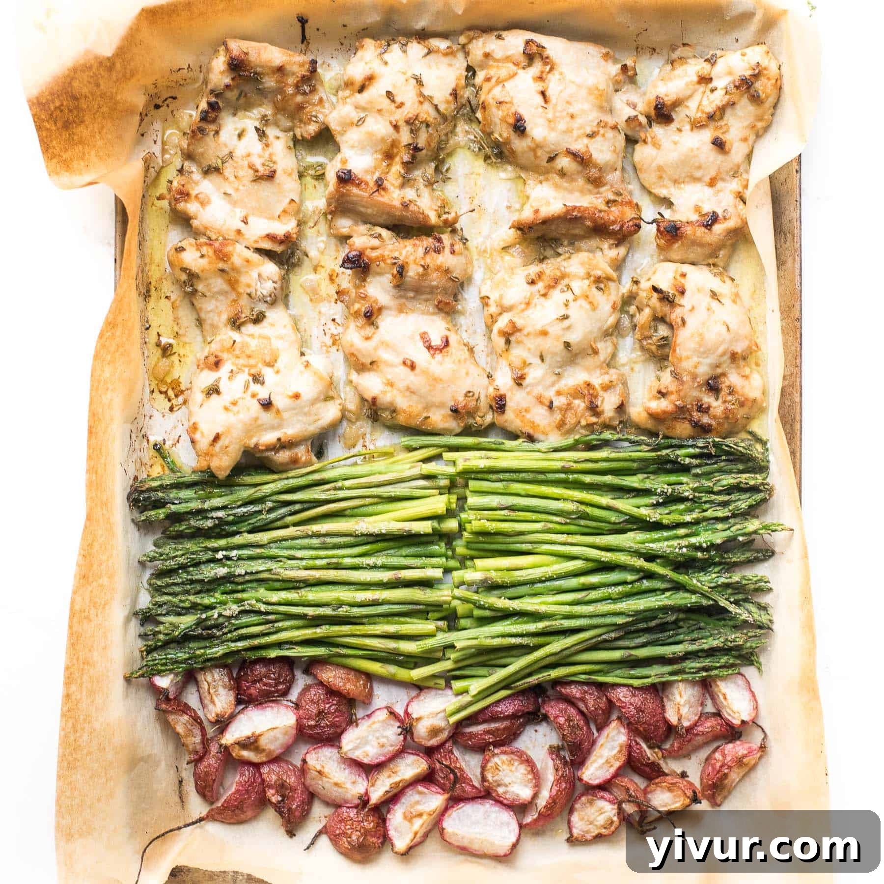Sheet pan dinner featuring dijon mustard chicken thighs, crisp asparagus, and roasted radishes.