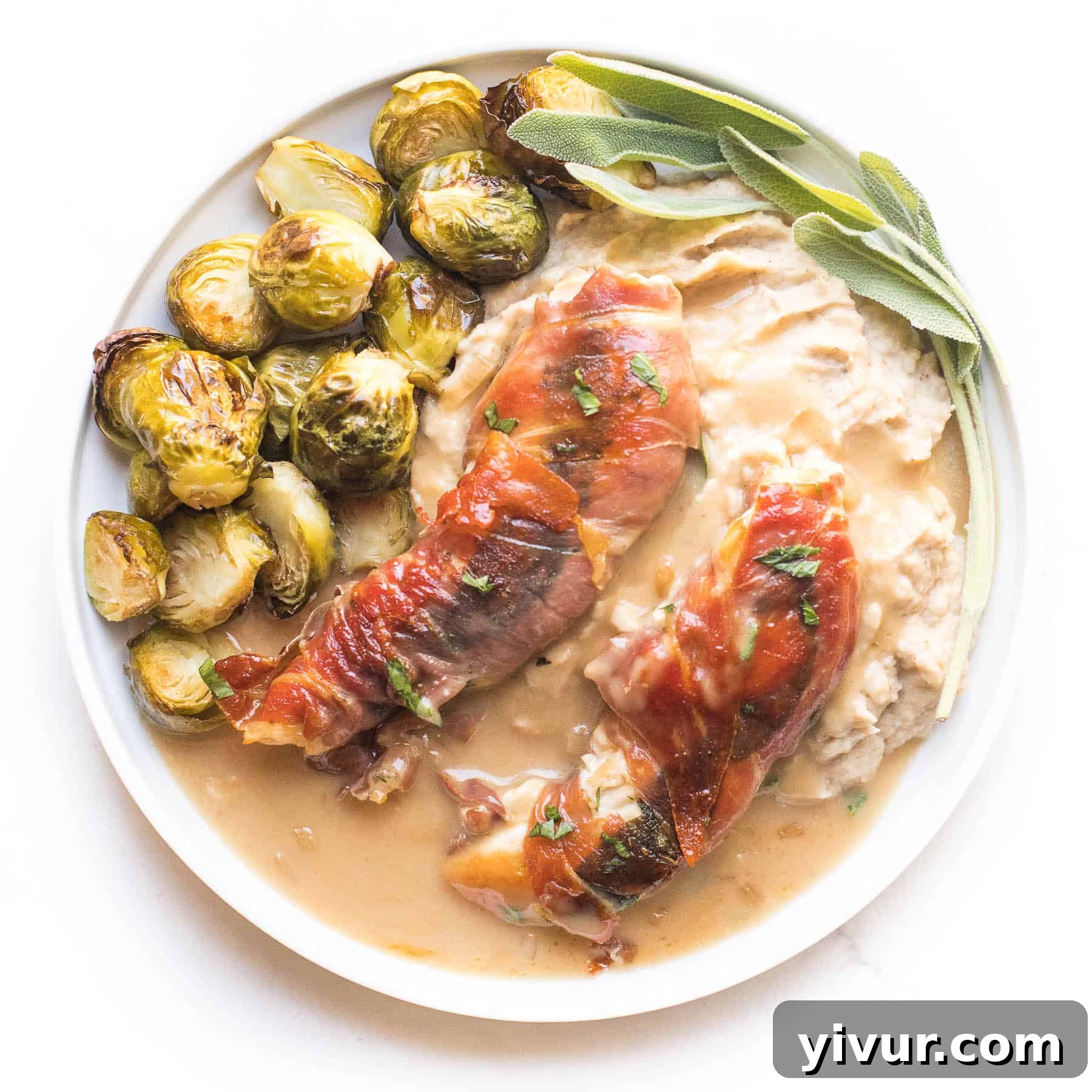 Chicken wrapped in prosciutto and smothered in a creamy apple cider sauce, a rich and flavorful keto and Whole30 dish.