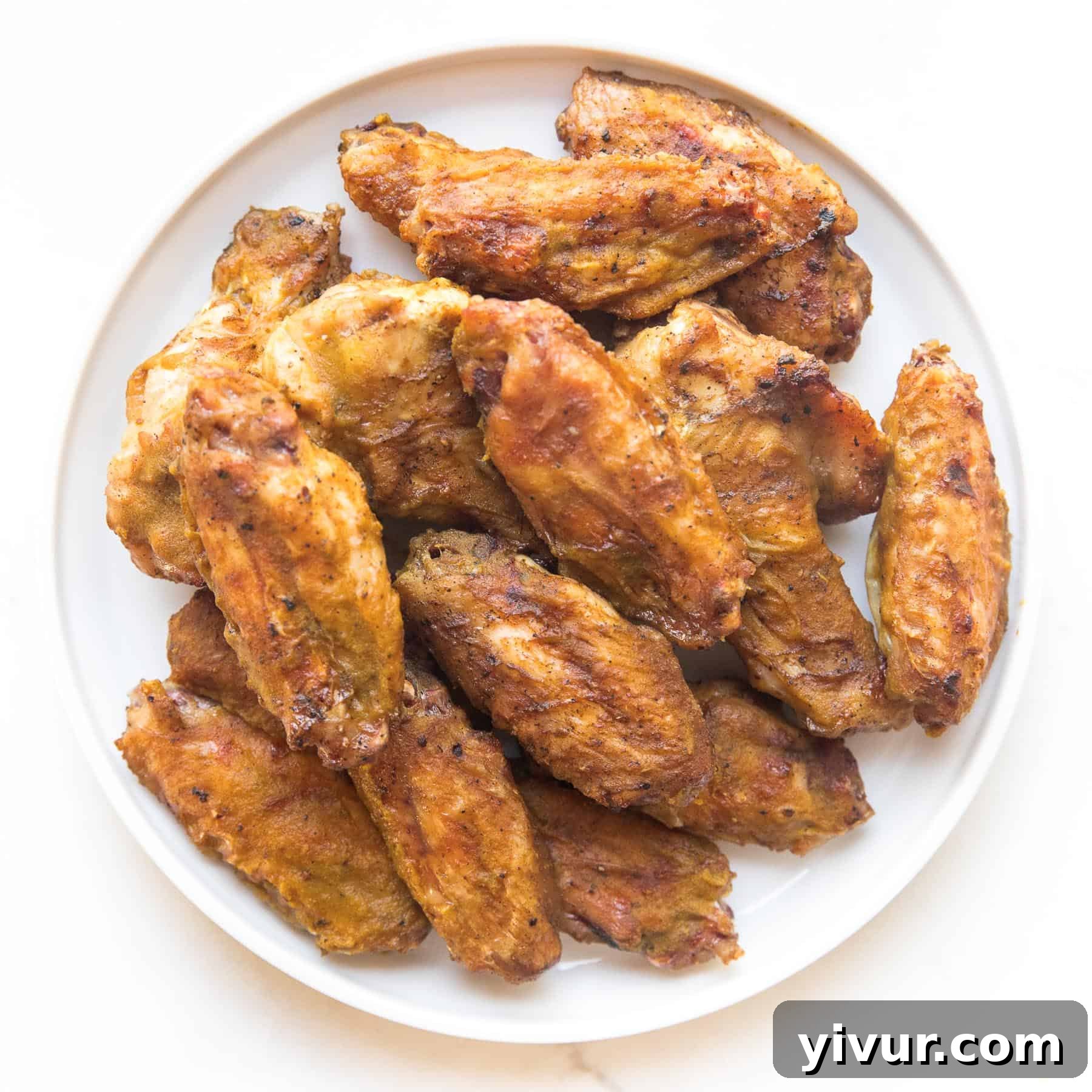 Crispy Keto BBQ chicken wings, tossed in a sugar-free barbecue sauce, ideal for game day or a casual meal.