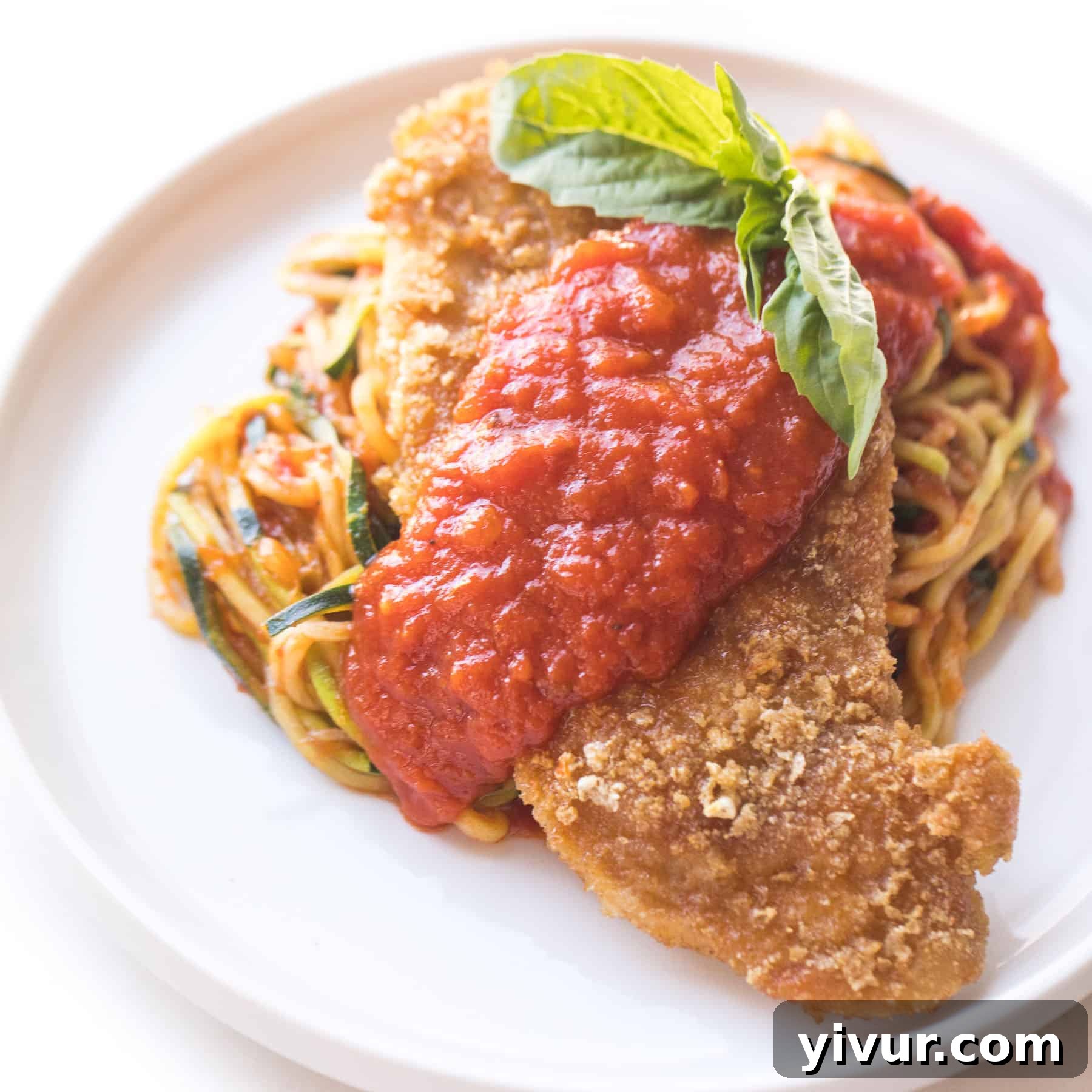 Dairy-free Keto chicken 'Parmesan' with rich tomato sauce, a satisfying and compliant meal.