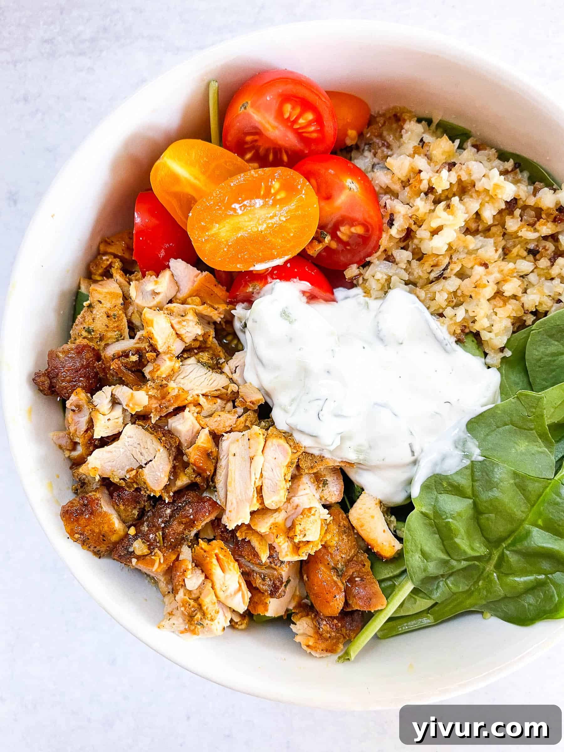 keto sheet pan chicken shawarma bowls in a white bowl with a white background