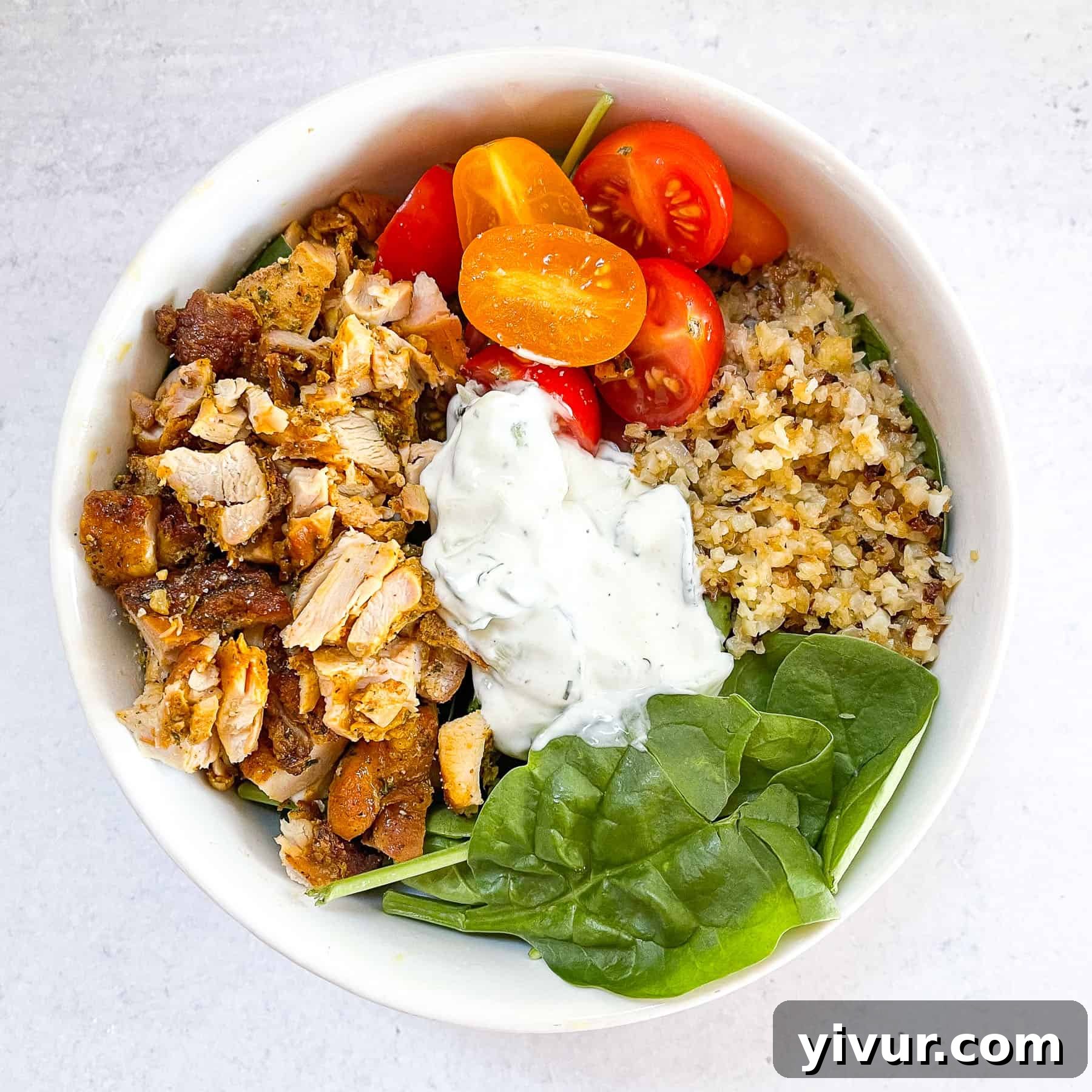 keto sheet pan chicken shawarma bowls in a white bowl with a white background