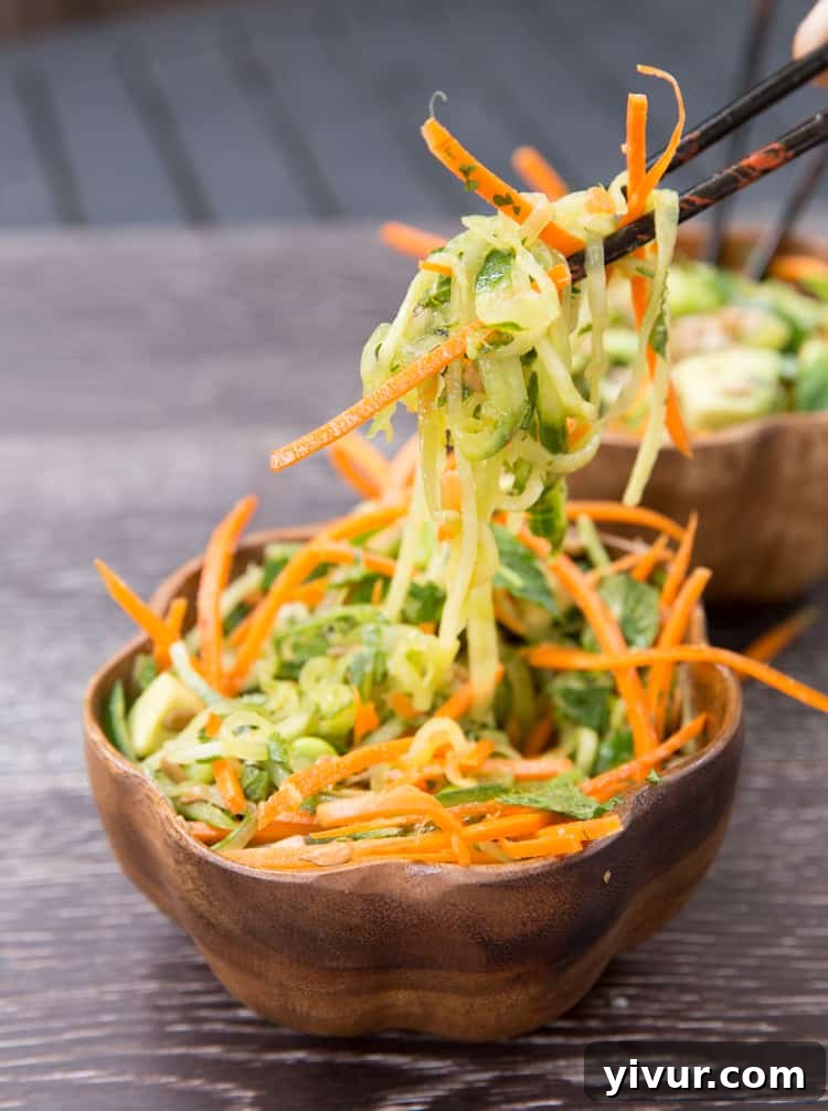 Freshly spiralized cucumber noodles and carrots for a Thai salad