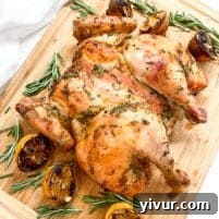 a whole chicken on a wooden cutting board