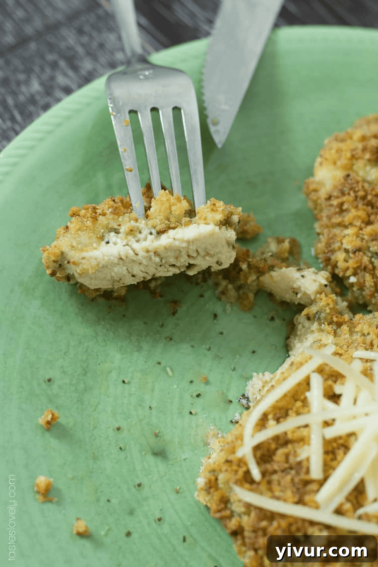 Pesto Parmesan Chicken Bake 4 bites of chicken parmesan on a green plate with a fork and knife