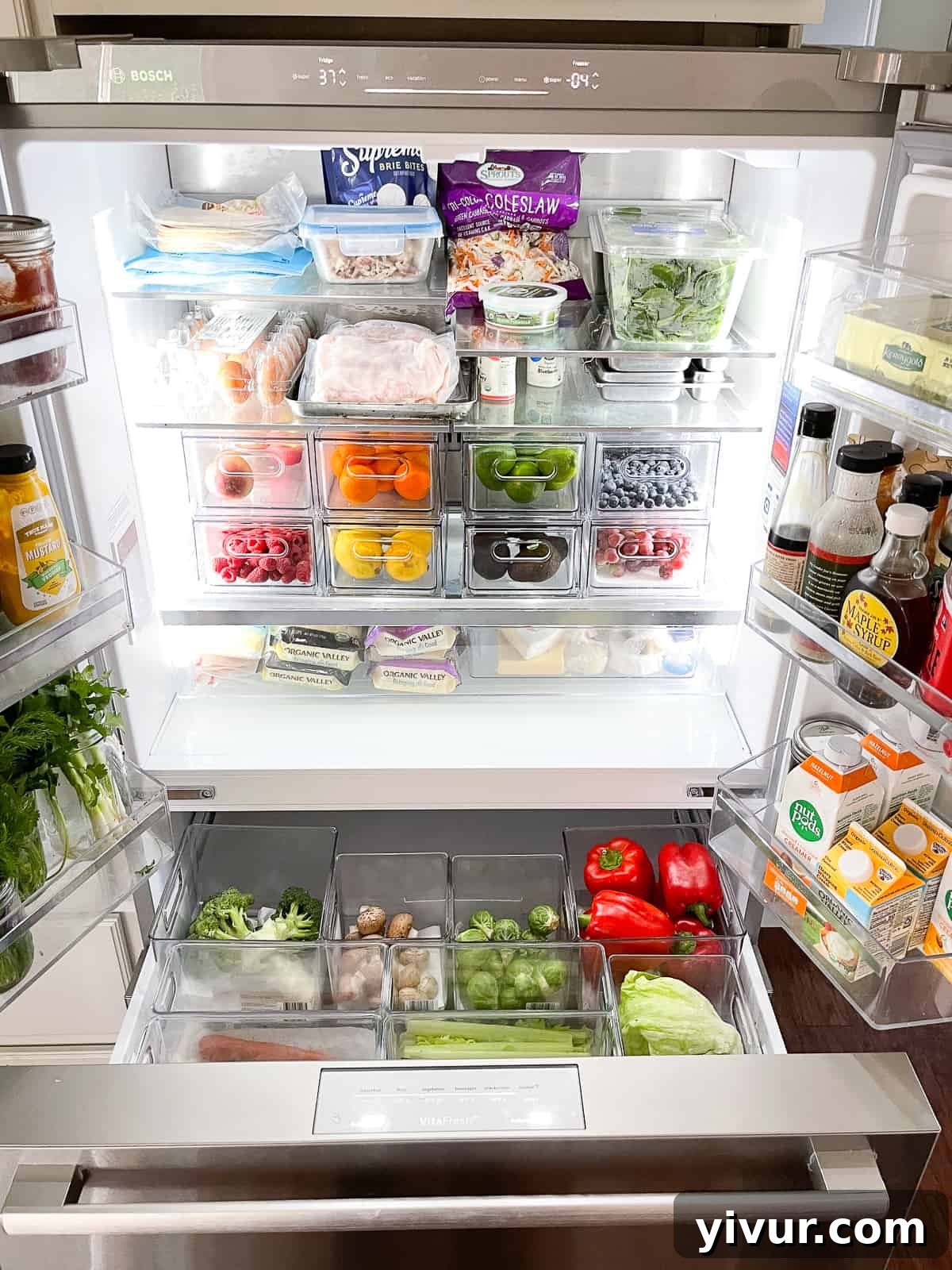 Smart Storage for Your Fridge 2 An impeccably organized refrigerator showcasing various organization containers filled with fresh produce.