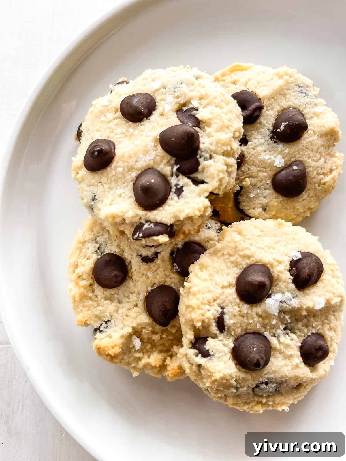 perfectly baked maple syrup chocolate chip cookies on a white plate, ready to be enjoyed