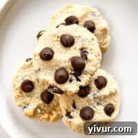 a stack of warm, golden brown maple syrup chocolate chip cookies with melted chocolate, on a white plate