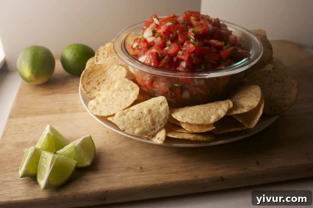 Pico de Gallo Freshly prepared Pico de Gallo, ready to be served with tortilla chips.