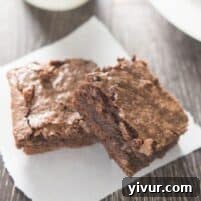 Homemade Fudgy Chewy Brownies: A top-down view of a round bowl filled with rich, dark brownie batter, ready for baking. The batter looks thick and luscious, promising a delicious dessert.