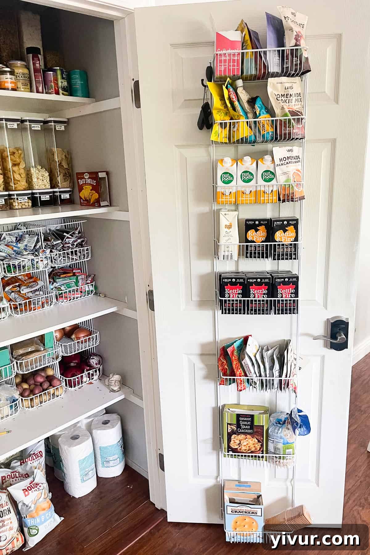 Pantry door opened, revealing a fully stocked wire rack door organizer with various food items