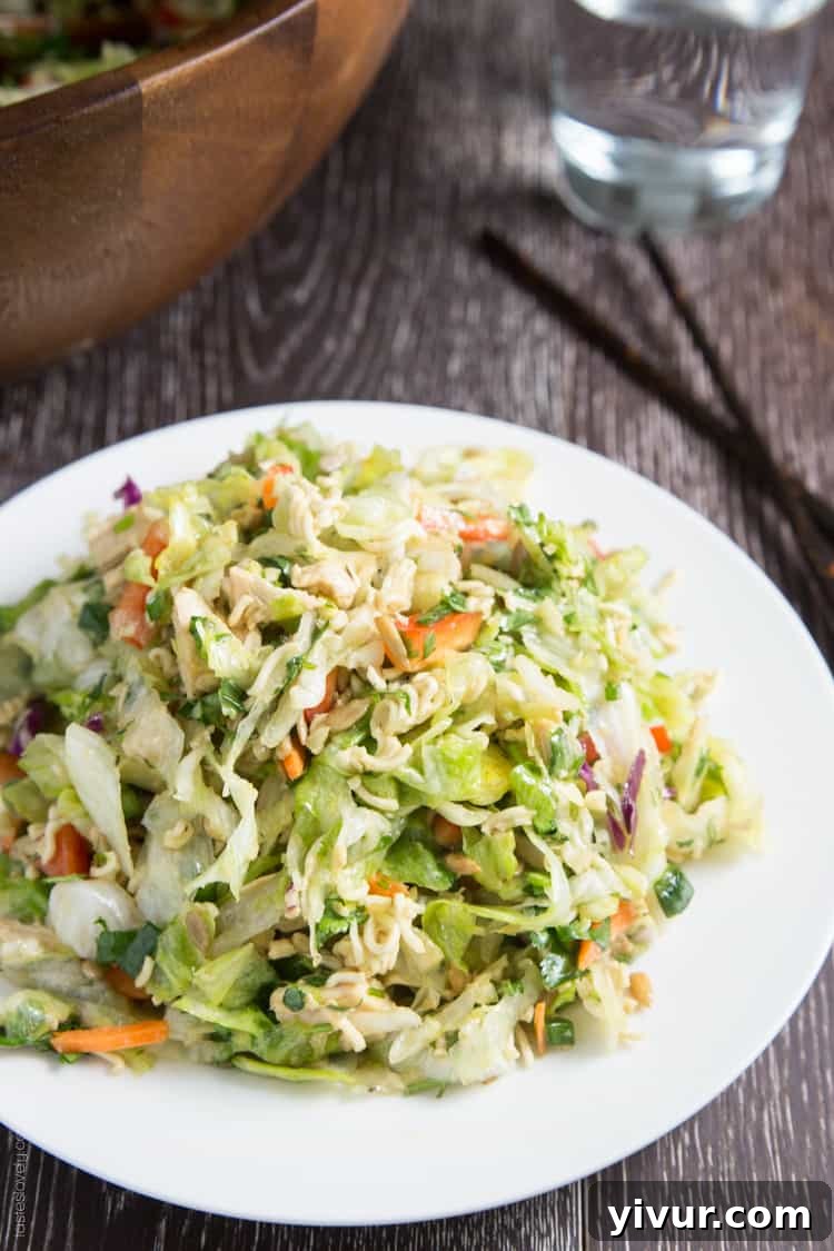 Delicious and Crunchy Ramen Noodle Chinese Chicken Salad served in a large bowl, garnished with fresh cilantro.