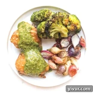 Crispy keto chicken thighs served with a vibrant orange parsley sauce.