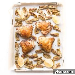 Keto Sheet Pan Greek Chicken with artichoke hearts, showing perfectly roasted chicken and vegetables.