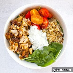 Keto Sheet Pan Chicken Shawarma Bowls beautifully arranged in a white bowl with a clean white background.