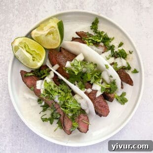 Make Dad's Day Delicious: Keto Recipes and Gift Ideas for Fathers Day 2022 7 steak tacos on jicama wrap on a white plate with lime and a white background