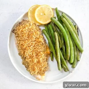 Make Dad's Day Delicious: Keto Recipes and Gift Ideas for Fathers Day 2022 16 keto crispy ranch chicken with green beans and lemon garnish on a white plate with a white background