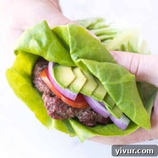 Make Dad's Day Delicious: Keto Recipes and Gift Ideas for Fathers Day 2022 6 a hand holding a burger that has a lettuce wrap