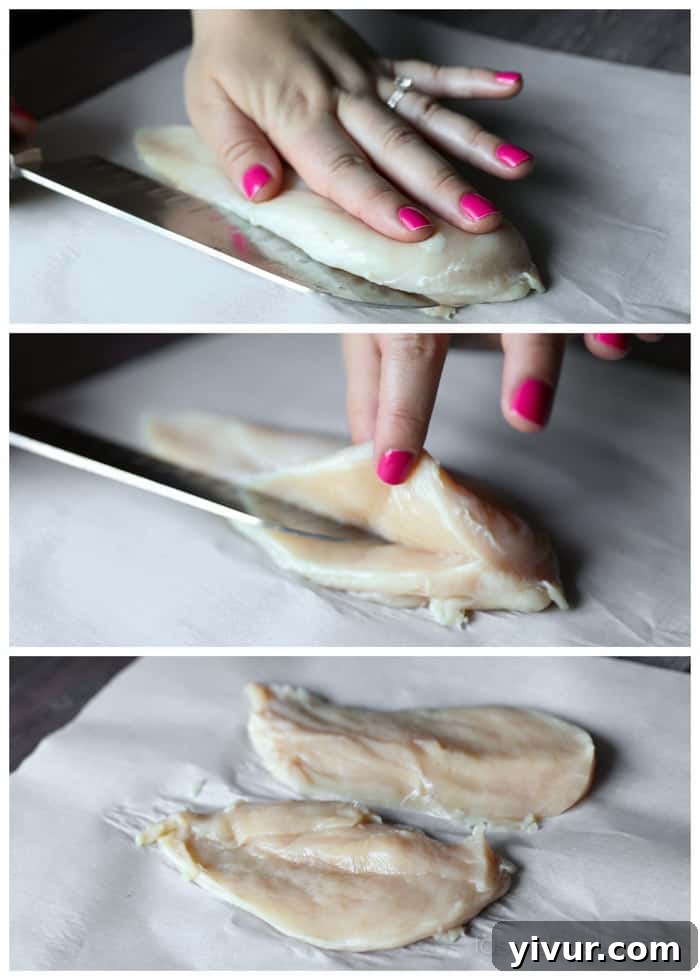Hands carefully slicing a chicken breast horizontally on a cutting board