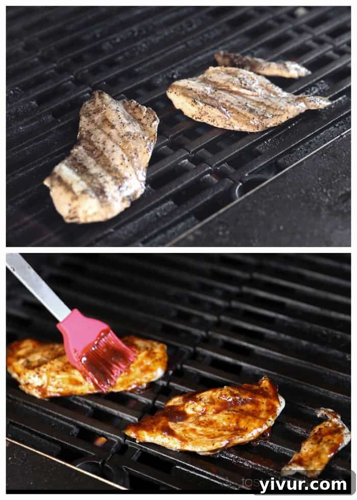 Two grilled chicken breasts coated in BBQ sauce, resting on a cutting board