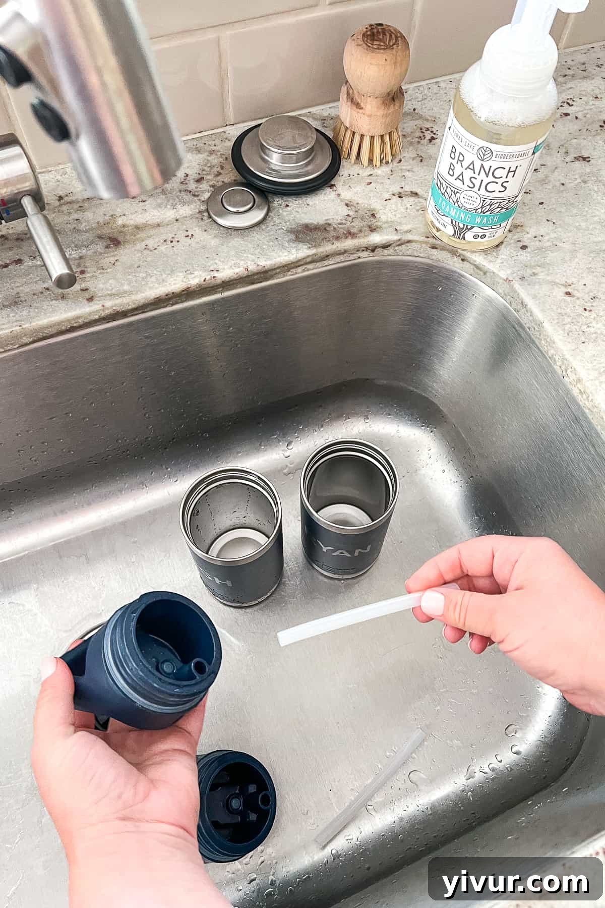 Disassembling Yeti water bottles by separating the lid, straw, and bottle components to prepare for a thorough cleaning.