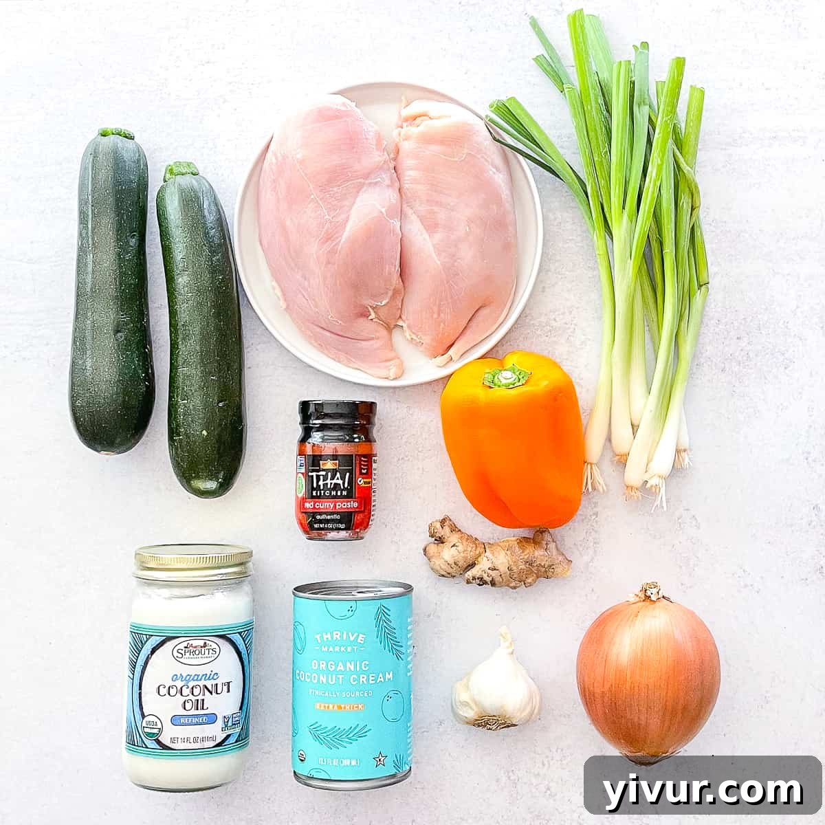 30-Minute Keto Thai Coconut Chicken Curry 3 Flat lay of raw ingredients for Thai red curry chicken including vegetables, spices, and coconut milk.