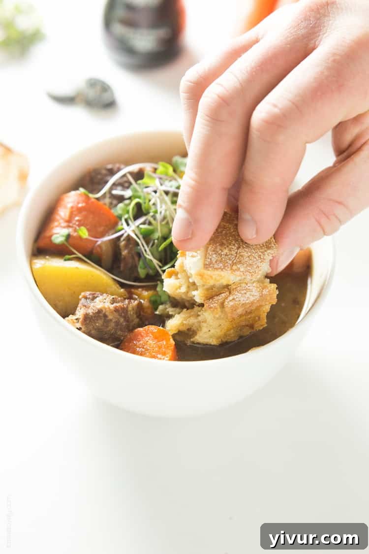 A bowl of Slow Cooker Irish Guinness Beef Stew garnished with microgreens