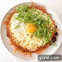 A beautifully presented crispy fried egg taco with cheddar cheese and fresh toppings.