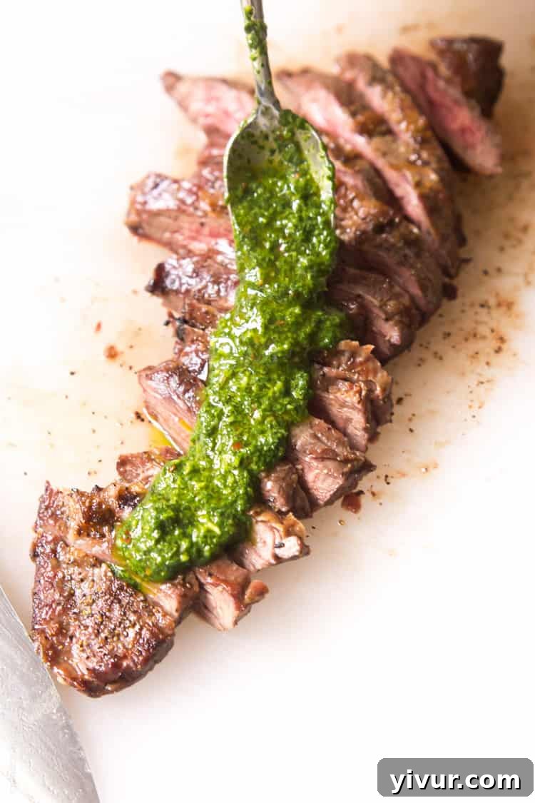 Perfectly grilled Skirt Steak served with a fresh, homemade Chimichurri Sauce. This easy and affordable recipe is suitable for Paleo, Whole30, gluten-free, and low-carb diets.