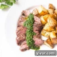 A vibrant close-up of Skirt Steak with Chimichurri Sauce, highlighting its fresh ingredients and perfect doneness.