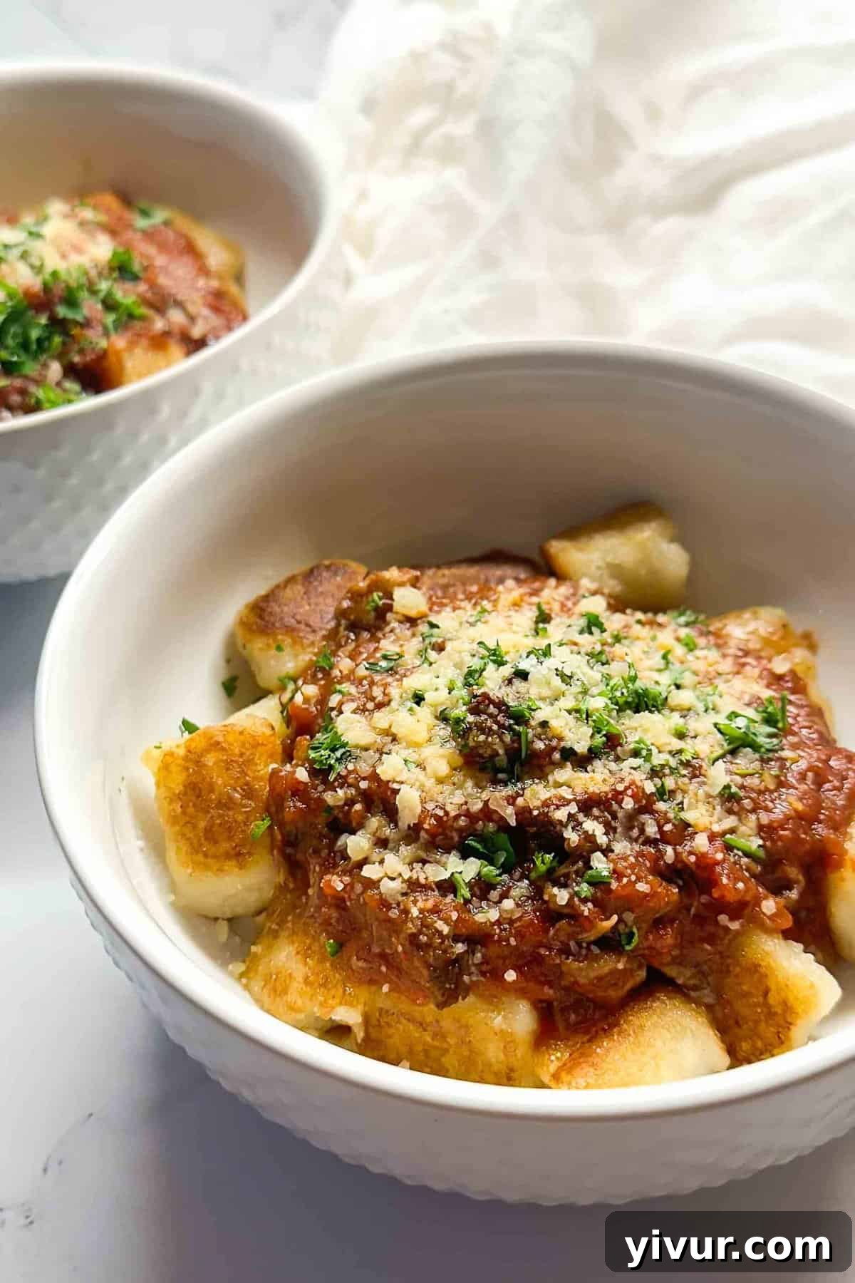 Effortless Instant Pot Beef Ragu 2 A hearty bowl of Instant Pot Beef Ragu, garnished with fresh parsley and grated Parmesan cheese, ready to be enjoyed.