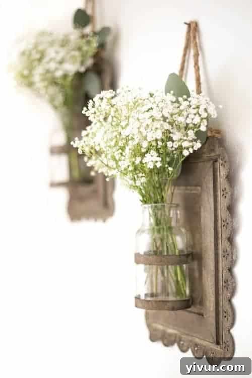 Lush white baby's breath flowers in elegant vintage hanging wall vases, creating a fresh spring decor