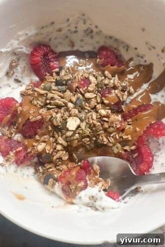High protein Greek yogurt bowl with mixed berries, nut butter, and grain-free granola