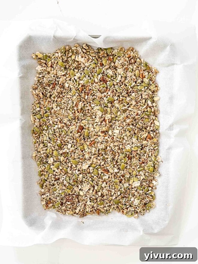 granola spread out on a baking sheet 