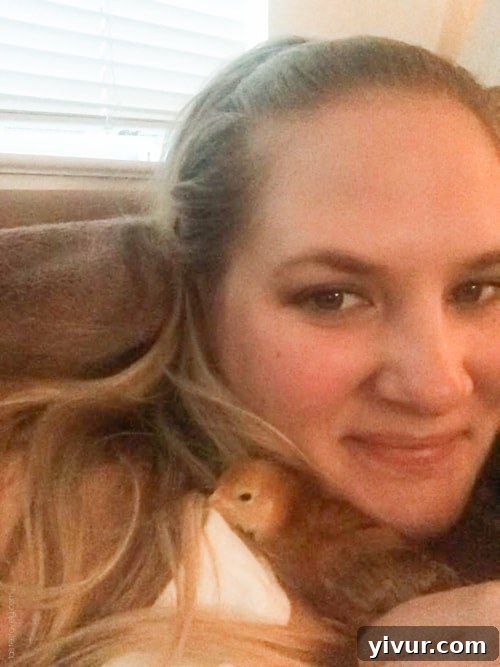 A chick, Rosie, gently burrows into human hair for warmth and comfort.