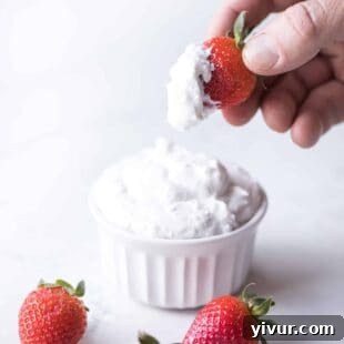 A bowl of fluffy coconut whipped cream, showcasing its light and airy texture, ready to be served.