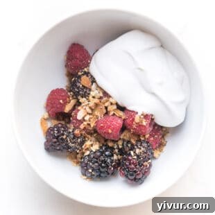 Whole30 + keto raw berry crisp: raspberries + blackberries topped with pecan + shredded coconut with coconut whipped cream
